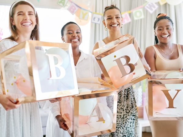 Women holding boxes filled with balloons.