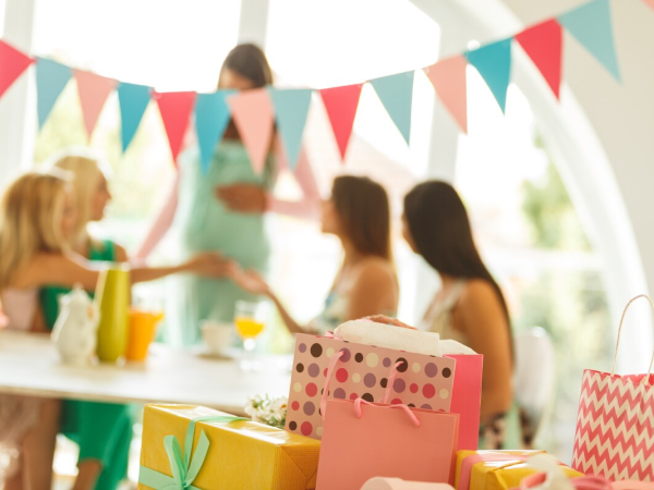 Gifts in the foreground with a table of women in the background.