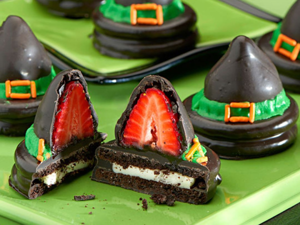 Oreo cookie and strawberry treats decorated to look like witches' hats. 