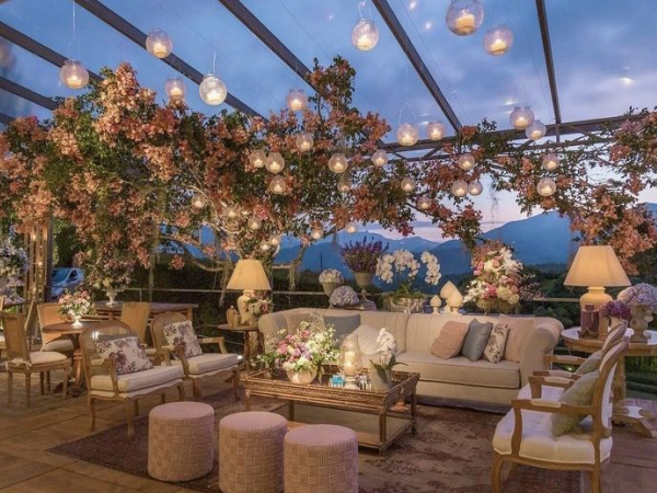 Beautifully decorated rooftop bar with mountains in the background.