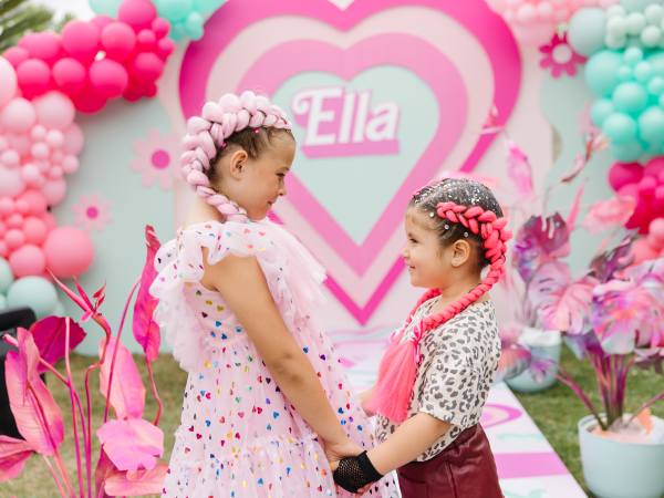 Two girls at a Barbie-themed birthday party.