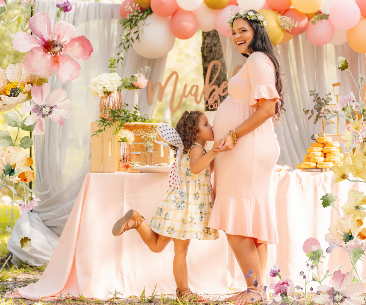 A little girl kissing her mom's stomach at a baby shower.