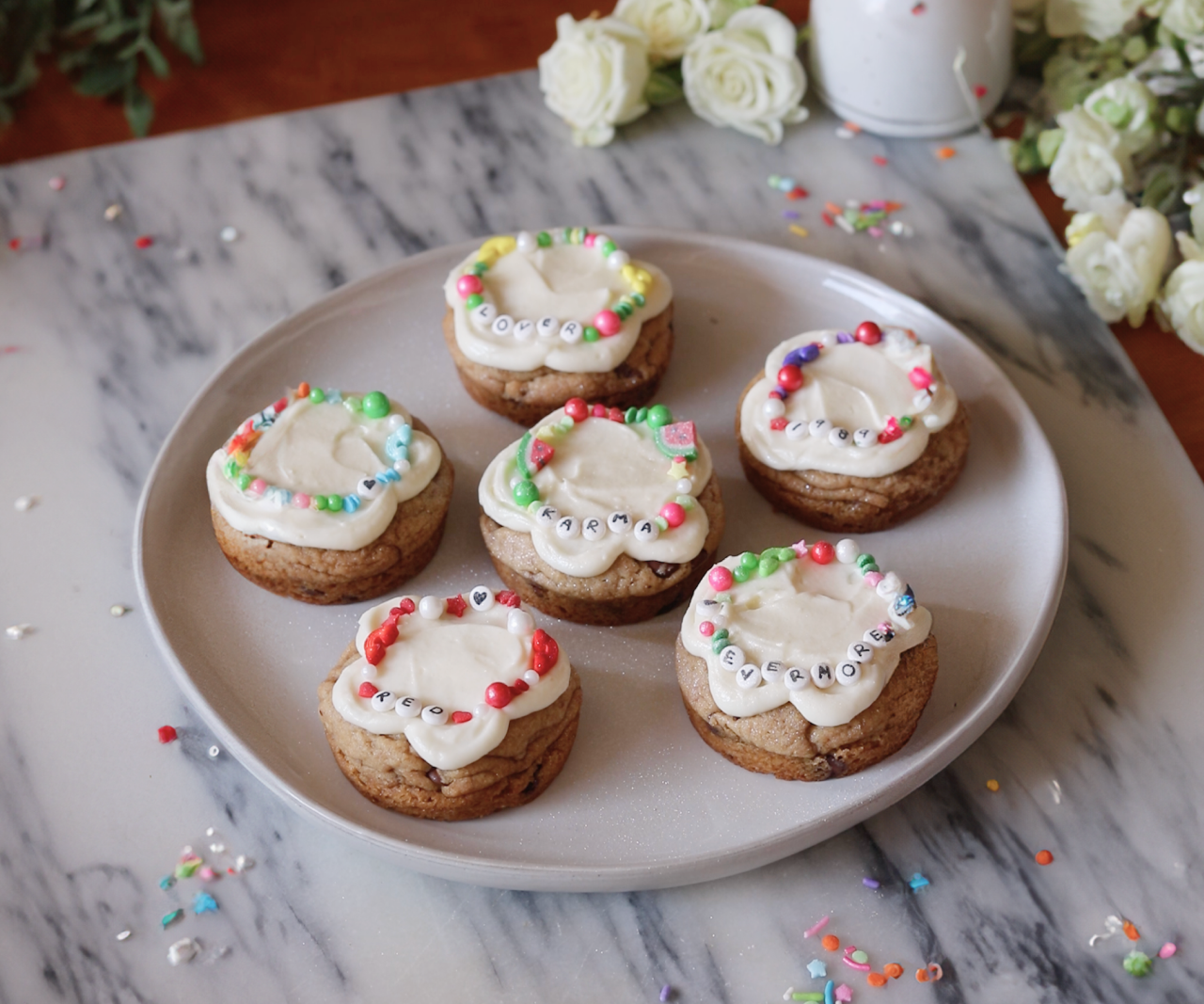 Plate of cookies decorated to look like there are friendship bracelets on them.